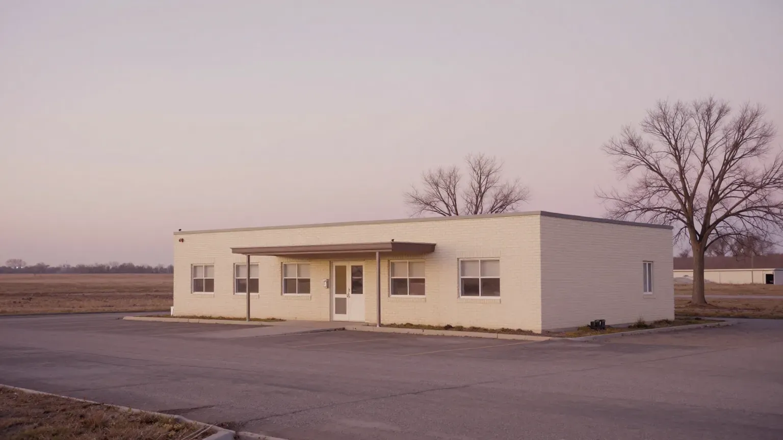 guide header — a small-town clinic exterior, morning